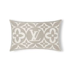 a gray and white pillow with an embroidered monogrammed v on it's side