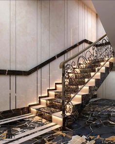 an elegant staircase with marble floors and handrails is lit up by lights on either side