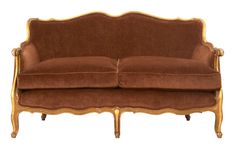 a brown couch with gold trim on the arm and back, sitting in front of a white background