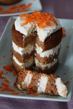 two pieces of carrot cake with white frosting and orange sprinkles on a plate