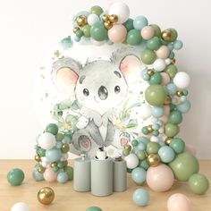 an image of a koala bear surrounded by balloon garlands and balloons in pastel colors