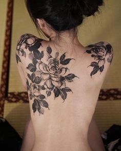 the back of a woman's body with flowers on it