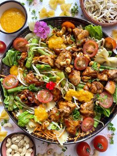 a salad with chicken, tomatoes, lettuce and other ingredients