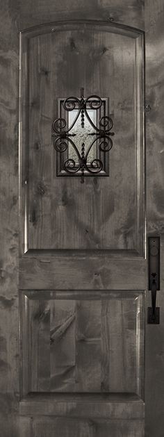 a black and white photo of a wooden door