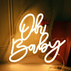 a neon sign that says oh baby on it