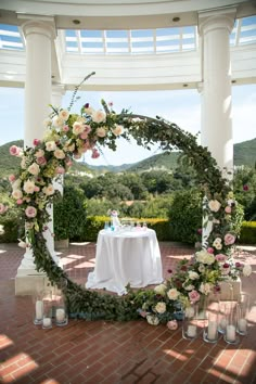 an outdoor ceremony setup with flowers and candles