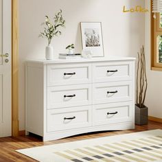 there is a white dresser with many drawers in the room and a plant on top