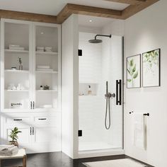 a bathroom with white cabinets and black tile flooring is pictured in this image, it has a walk - in shower