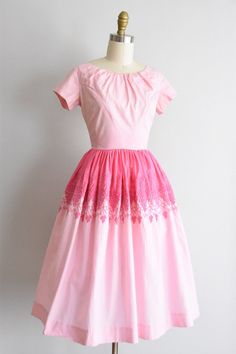 "Vintage 1950s cotton dress. Two tone pink with grape and vine embroidery near waistline. Capped sleeves, scoop collar, and piped waistband. Full skirt. Back metal zipper closure. State of garment | ok, some light color transfer near waist, refer to photos. one tiny spot on shoulder and skirt. one super faint yellow spot on skirt. being sold as is. Measurements ✂--- best fit | Extra Small / Small bust | 34\" shoulders | 14.5 shoulder to waist | 14.5\" sleeves | 5\" waist | 25\" hips | free total 1950s Style Pink Tea-length Dress, 1950s Style Pink Dress For Vintage Fashion, 1950s Pink Vintage Dress, 1950s Style Pink Vintage Dress, Pink 1950s Vintage Style Dress, Pink 1950s Vintage Dress, Pink 1950s Vintage Fashion Dress, Pink Cotton Vintage Dress For Garden Party, 1950s Pink Vintage Dress With Short Sleeves