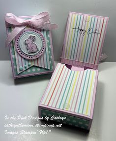 an open box with a pink bow on the top and another card in the bottom