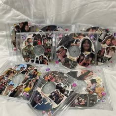 four cd cases with pictures on them and confetti around the edges, all in clear plastic