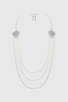 This sumptuous piece of jewelry features a retro-elegant yet slightly modern style that complements the lavish garments, reminiscent of the roaring 1920s. Features: Lustrous imitation pearls Necklace and earrings set Multi layer design 8mm pearls Note: This item is limited to GROUND SHIPPING ONLY. If expedited shipping is selected at checkout, all other items will be shipped via expedited shipping, while this item will be shipped separately by ground shipping. 1920 Accessories, Roaring 20s Jewelry, 20s Jewelry, 1920s Accessories, 1920s Jewelry, 1920s Headpiece, Roaring 1920s, Bridal Pearl Necklace, Pearl Necklace Vintage