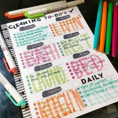 an open planner with markers and pens on it next to some other writing materials,