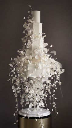 a wedding cake with white flowers on top