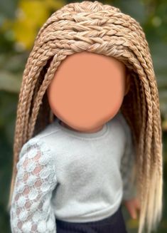 a doll with long blonde hair wearing a sweater