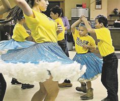 several people are doing various dances in a room