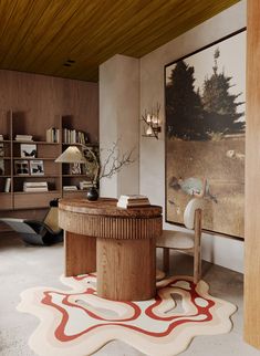 a living room with a large painting on the wall next to a chair and table