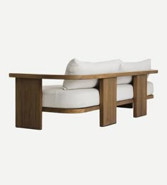 a wooden bench with white cushions on it