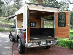 the truck is parked on the side of the road with it's doors open