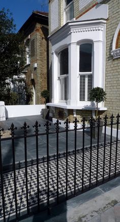 a black and white fence next to a building