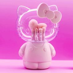 the hello kitty makeup brush holder is made out of plastic and has multiple brushes in it