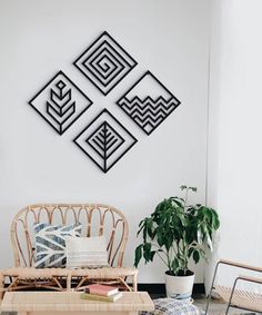 a living room filled with furniture next to a wall mounted art piece on the wall