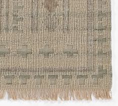 an area rug with fringes on the bottom and one piece of fabric in the middle