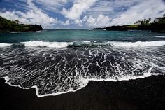 an ocean view with waves crashing on the shore