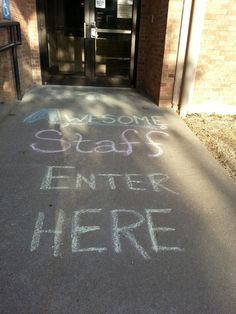 a sidewalk with chalk writing on it that says welcome stags and enter here