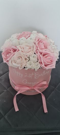 a pink birthday cake with roses in it