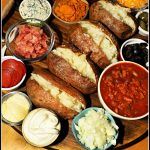 a wooden table topped with lots of different types of food