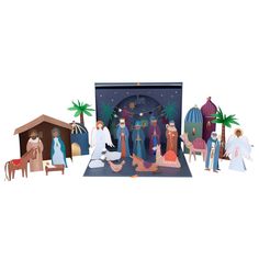 a nativity scene with figurines and paper cutouts on a white background