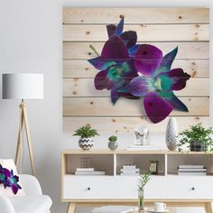 a living room with white furniture and purple flowers on the wood paneled wall behind it