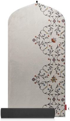 a white rug with an intricate design on the front and back side, in various colors