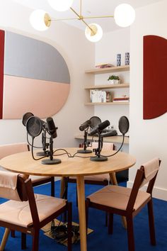 two microphones sitting on top of a wooden table in front of a circular mirror