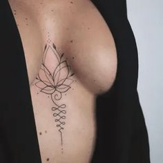 a woman's breast with a tattoo design on her left arm and the other side