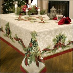 the table cloth is decorated with holly and poinsettis on it for christmas