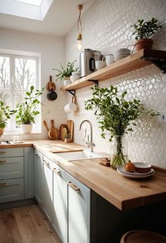 a kitchen filled with lots of wooden counter tops and green plants on top of the counters