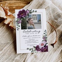 a card with flowers on it sitting on a bed next to a flower headband