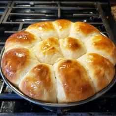 a freshly baked bread sitting on top of an oven burner in front of it