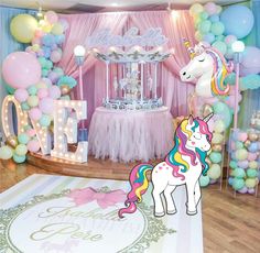 a room decorated with balloons and decorations for a baby's first birthday or party