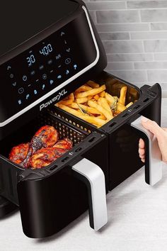 the air fryer is full of food and fries