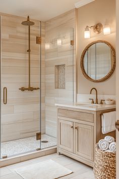 a bathroom with a walk in shower next to a sink and mirror on the wall