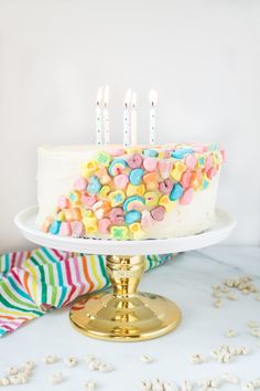 a birthday cake with white frosting and colorful candy sprinkles on it