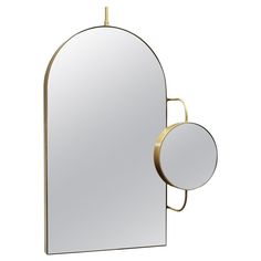 an oval mirror with a gold frame and two circular mirrors on the wall, both side by side