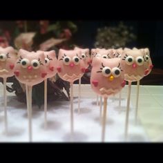 there are hello kitty lollipops on the stick with pink frosting and eyes