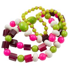 This playful extra-long Bakelite and Lucite beaded necklace features assorted beads in various shapes: round, square stick, tomato, and ovoid. The piece boasts a mix-and-match of flashy colors, apple green marble, hot pink, fuchsia, and custard marble contrasted with white Lucite beads. The necklace hangs very nicely around the neck. There is no closing clasp on the vintage link, which is still very safe to wear. Vintage beads from the 1950s, this necklace was rebuilt in the early 1980s. Please Briolette Necklace, Chrome Tourmaline, South Sea Pearl Necklace, Deco Beads, Bakelite Jewelry, Vintage Beads Necklace, Pink Apple, Vintage Beads, Carnelian Beads