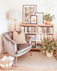 a living room filled with furniture and bookshelves next to a wall covered in pictures