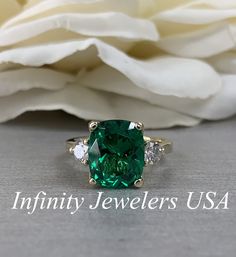 Emerald Engagement Ring, Elongated Cushion Emerald Ring With Moissanite Accents, May Birthstone Ring, Emerald Ring In 14K Yellow Gold #6720 #MayBirthstone #MoissaniteRing #EngagementRing #6720 #AnniversaryGift #14kYellowGold #EmeraldRing #InfinityJewelersUSA #LadiesRing #ElongatedCushion Luxury Gold Emerald Ring Birthstone, Luxury Gold Emerald Ring With Diamonds, Cushion Emerald Engagement Ring, Cushion Emerald Ring, Green Moissanite Jewelry In Radiant Cut, Green Moissanite Jewelry With Radiant Cut, Green Moissanite Radiant Cut Jewelry, Green Radiant Cut Moissanite Jewelry, Green Baguette Cut Jewelry With Accent Stones