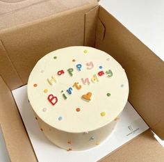 a birthday cake in a box with the words happy birthday written on it